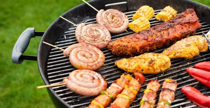 Vlees op een houtskoolgrill met vlammen